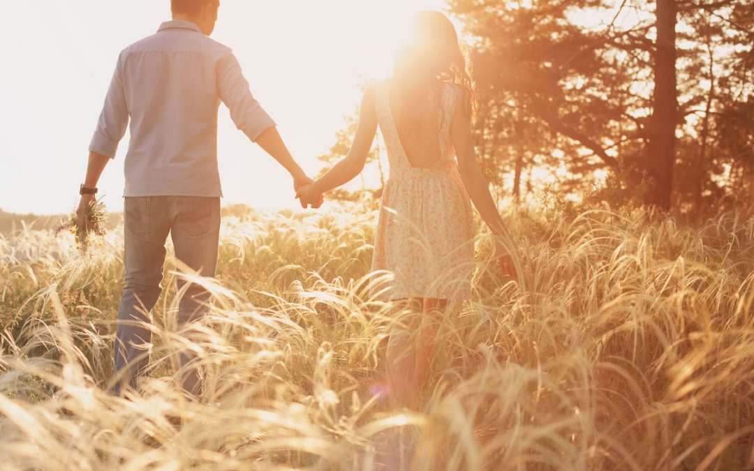 Couple walking in a field