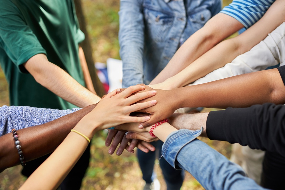 mixed race international group of people gathered together