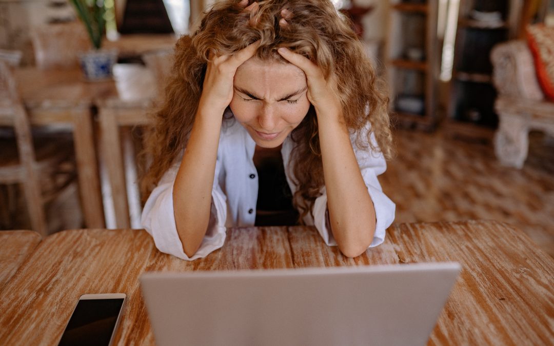 Frustrated woman at her laptop