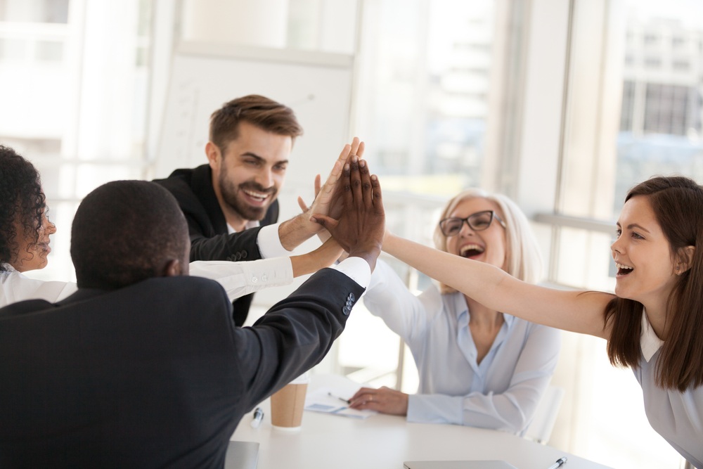 Co workers celebrating with high fives