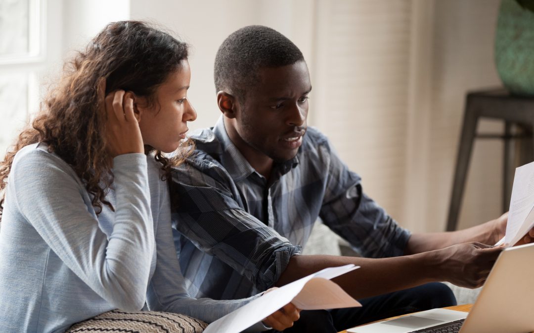 Stressed black couple with bills