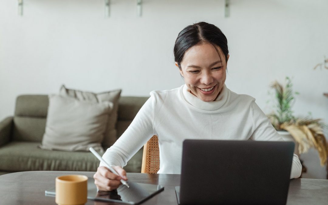 Asian business woman looking at her laptop