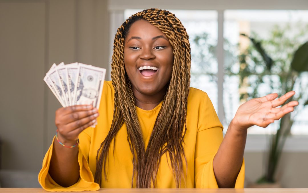 African American woman holding dollars