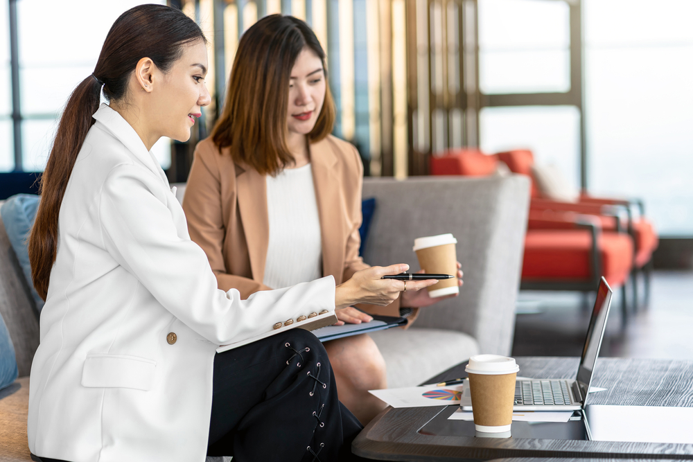 Two asian businesswomen discussing with the partner business