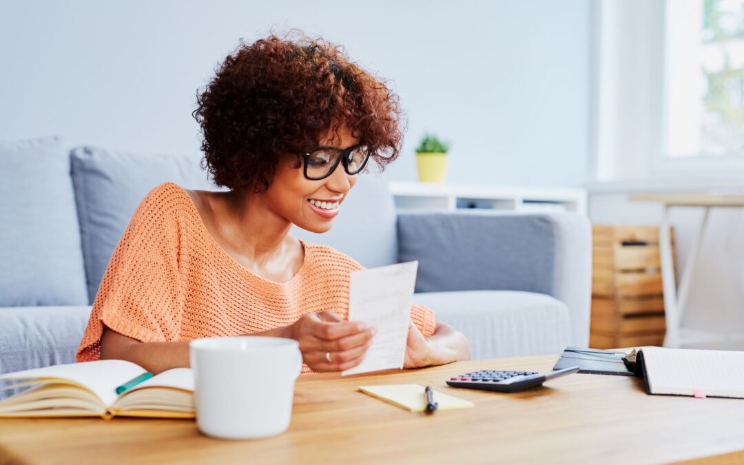 Young African American woman looking at receipts and smiling