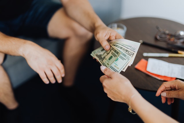 Man handing money to a women