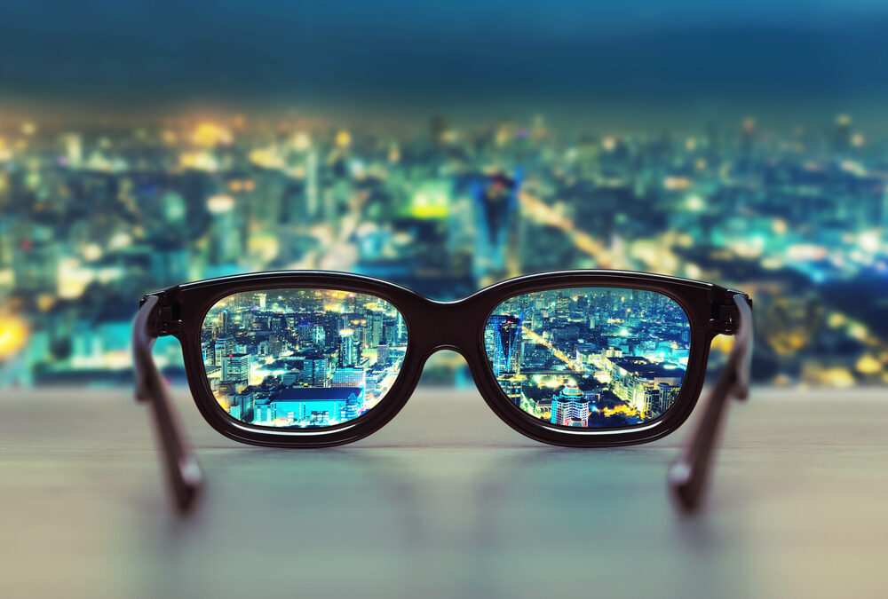 Night cityscape focused in glasses lenses.